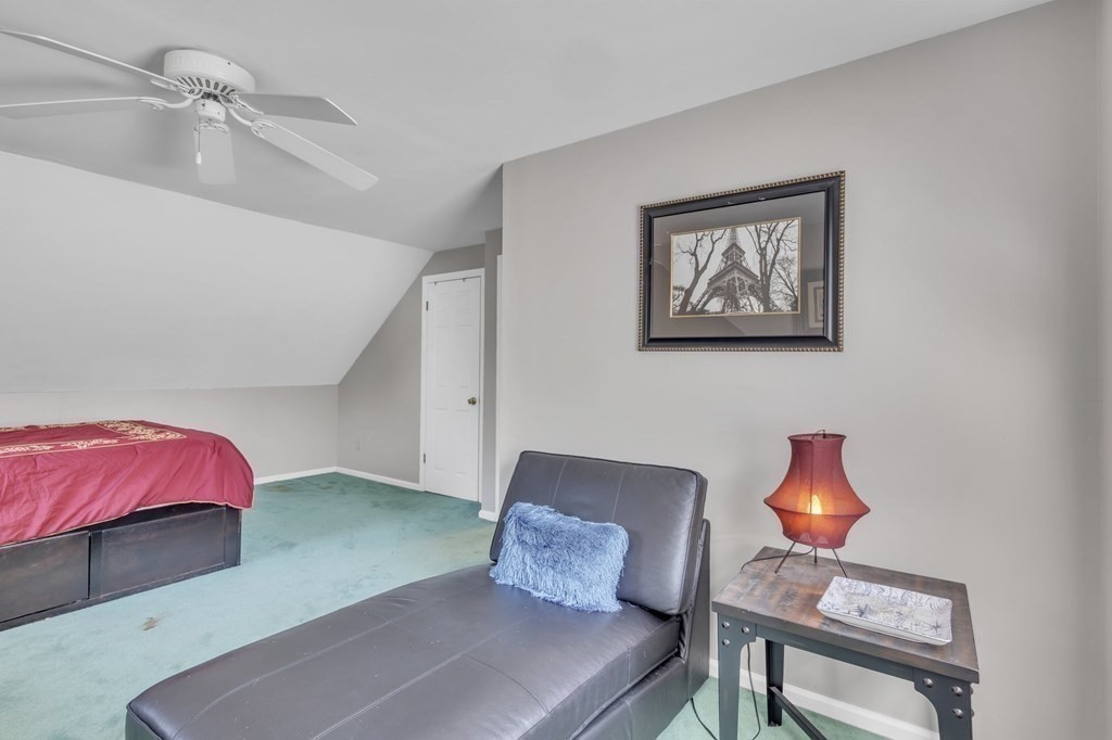 1638 Parker Street Springfield, MA 01128 - Photo 21 of 36 a bedroom with a bed and a lamp on the dresser