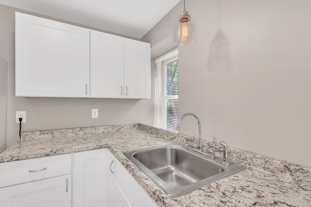 1638 Parker Street Springfield, MA 01128 - Photo 27 of 36 a kitchen with granite countertop a sink and cabinets