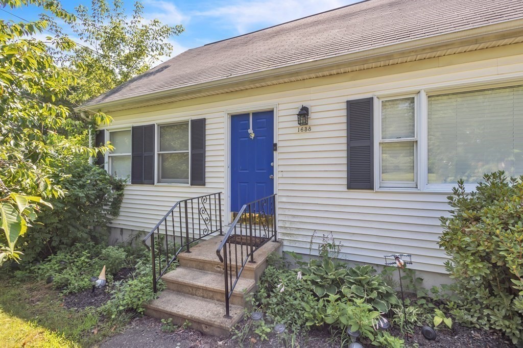 1638 Parker Street Springfield, MA 01128 - Photo 3 of 36 a front view of a house with a garden