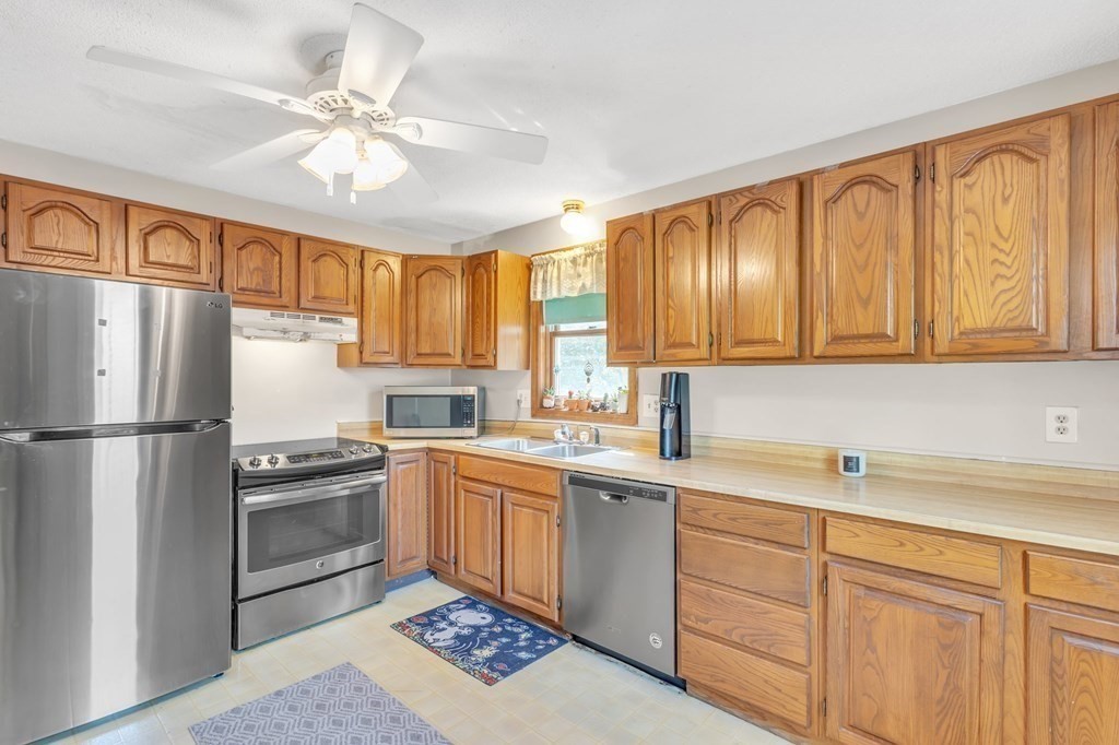 1638 Parker Street Springfield, MA 01128 - Photo 4 of 36 a kitchen with a sink stainless steel appliances cabinets and a window