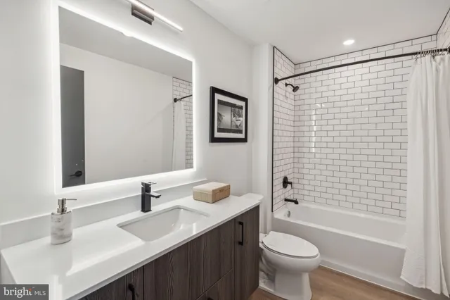 a bedroom with a bed and a refrigerator