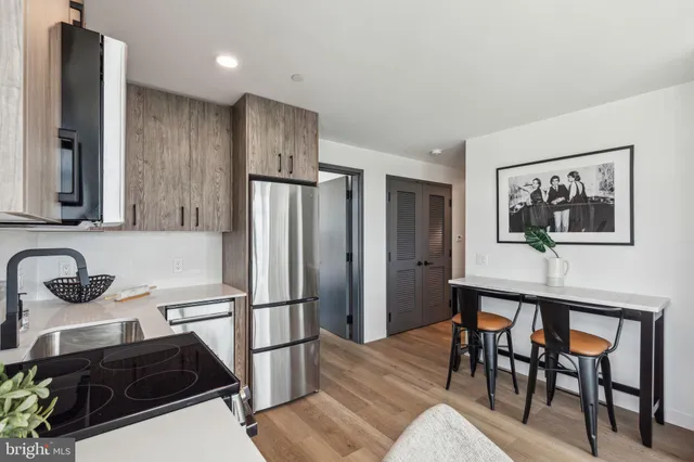 a kitchen with stainless steel appliances a stove a microwave and refrigerator