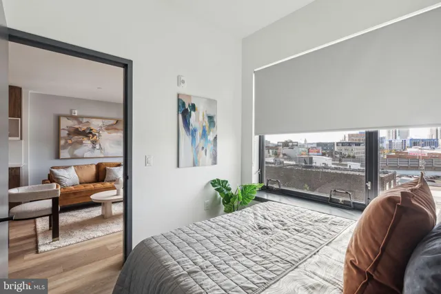 a bedroom with furniture and a large window