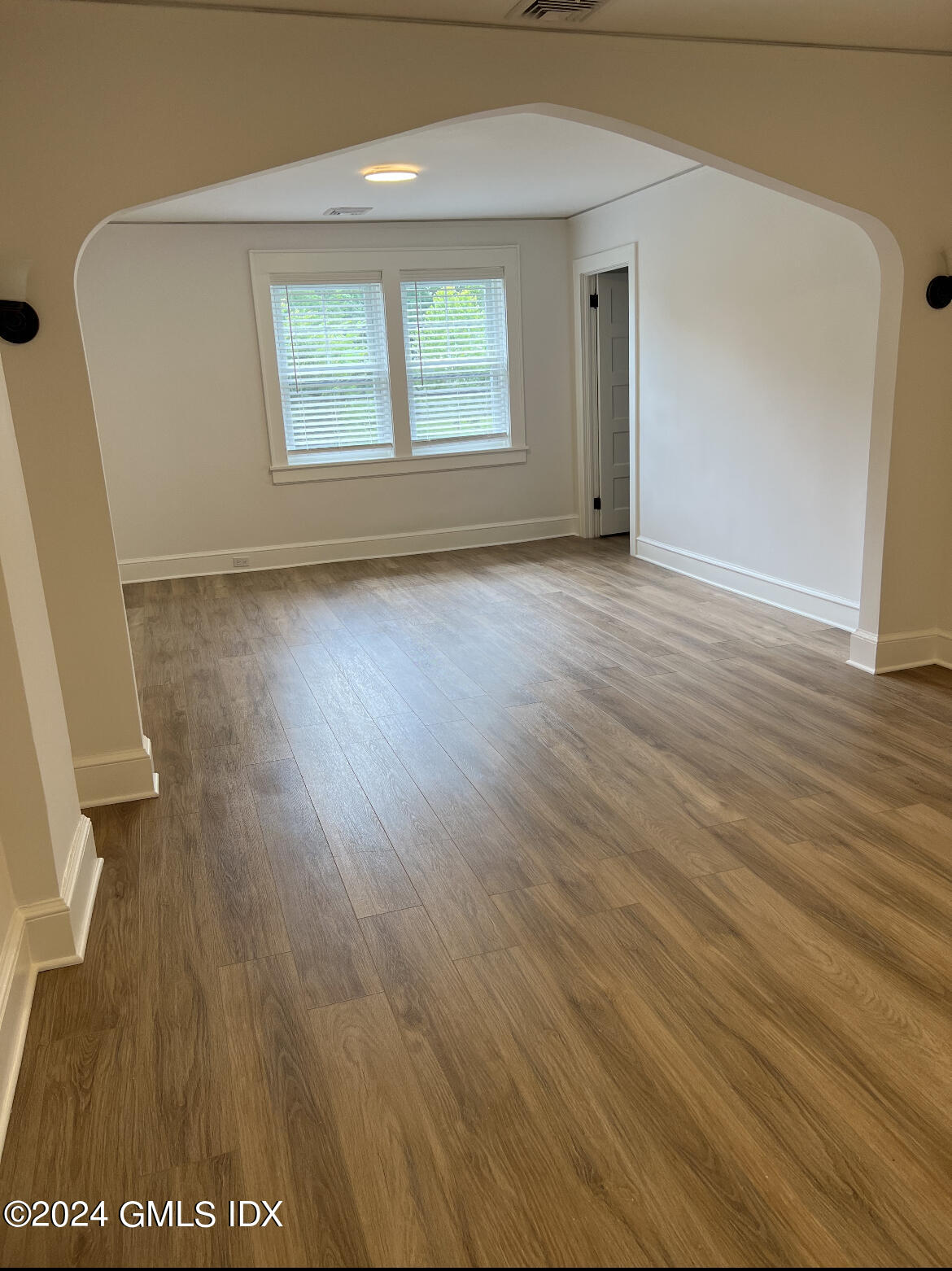 45 Bible Street, Unit 2 Cos Cob, CT 06807 - Photo 4 of 12 an empty room with wooden floor and windows