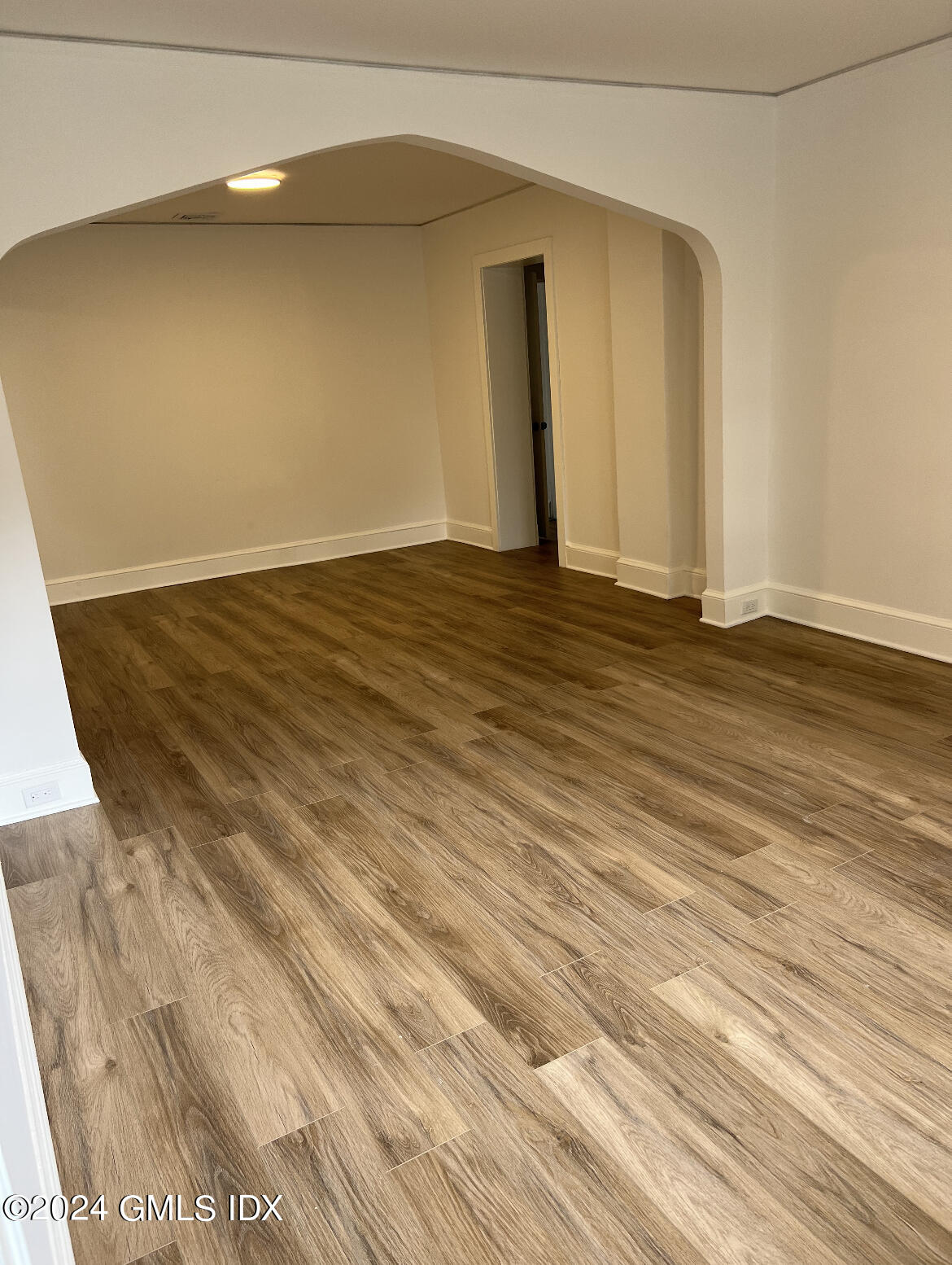 45 Bible Street, Unit 2 Cos Cob, CT 06807 - Photo 5 of 12 an empty room with wooden floor and windows