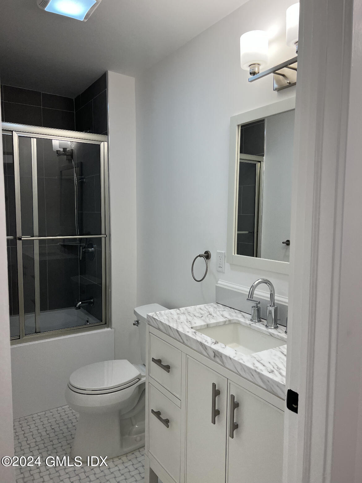 45 Bible Street, Unit 2 Cos Cob, CT 06807 - Photo 7 of 12 a bathroom with a granite countertop sink a toilet and shower