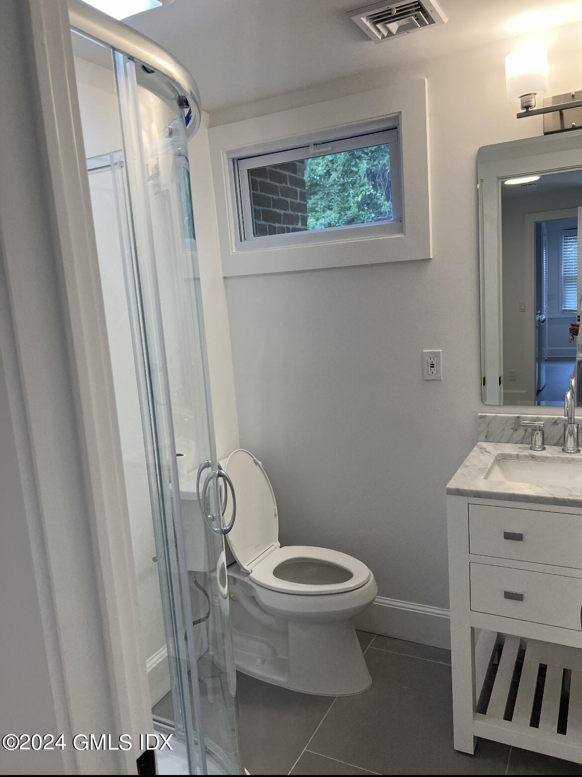 45 Bible Street, Unit 2 Cos Cob, CT 06807 - Photo 9 of 12 a white toilet sitting next to a bathroom sink