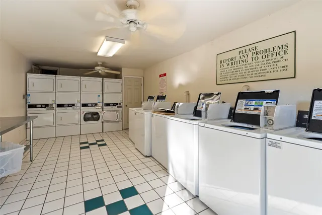a kitchen with granite countertop a stove a sink and a refrigerator