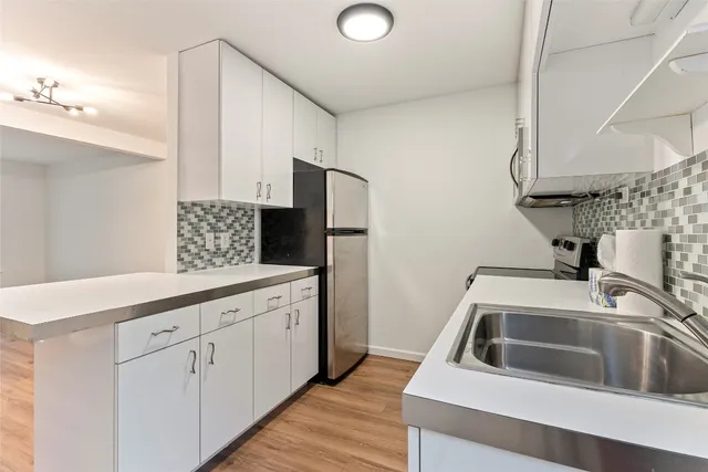 a kitchen with a sink and a refrigerator