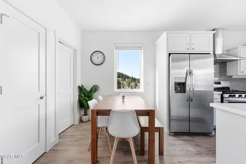 a kitchen with stainless steel appliances a refrigerator and a table