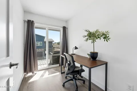 a view of a workspace with a window and outside view