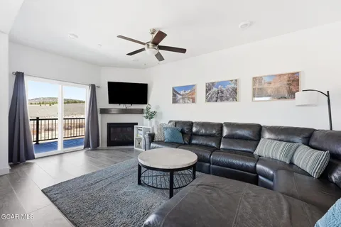 a living room with furniture a rug and a flat screen tv