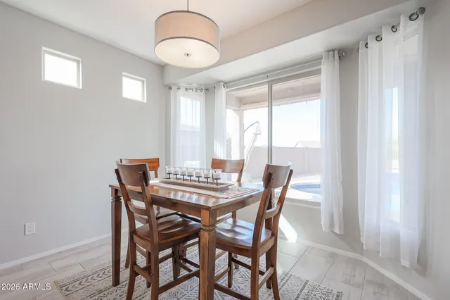 a view of a dining room with furniture and window