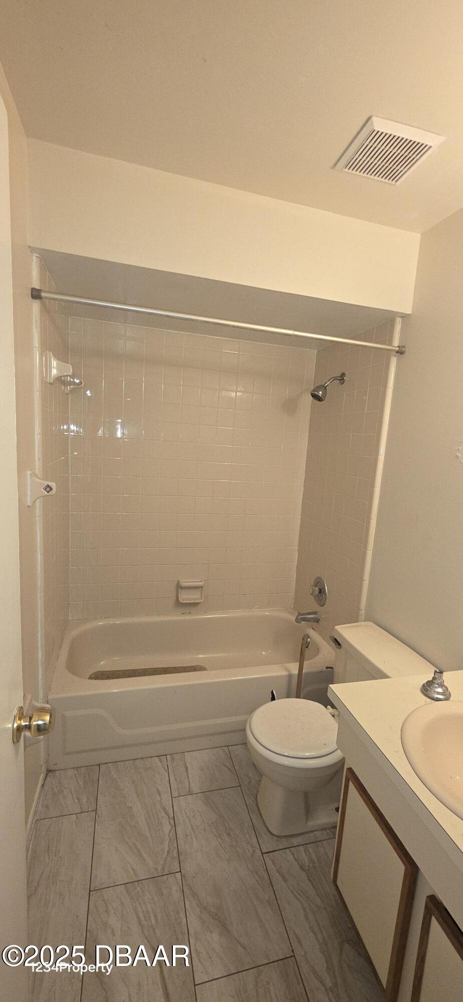 12136 Sand Pebble Way Orlando, FL 32824 - Photo 13 of 14 a bathroom with a granite countertop sink a toilet a mirror and shower