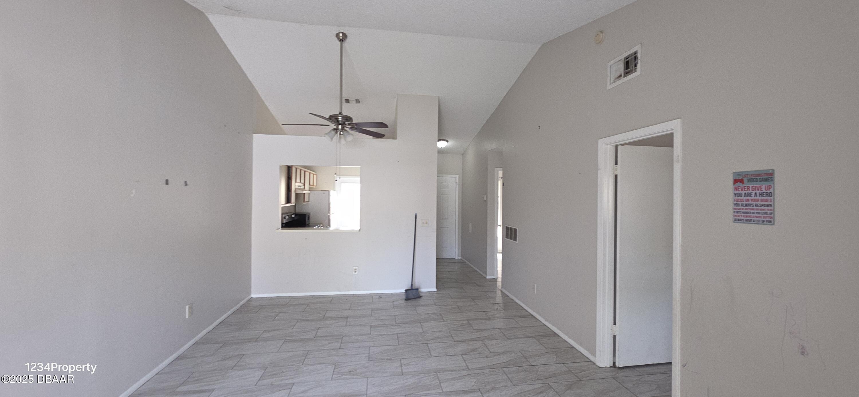 12136 Sand Pebble Way Orlando, FL 32824 - Photo 7 of 14 a view of a hallway with a chandelier fan