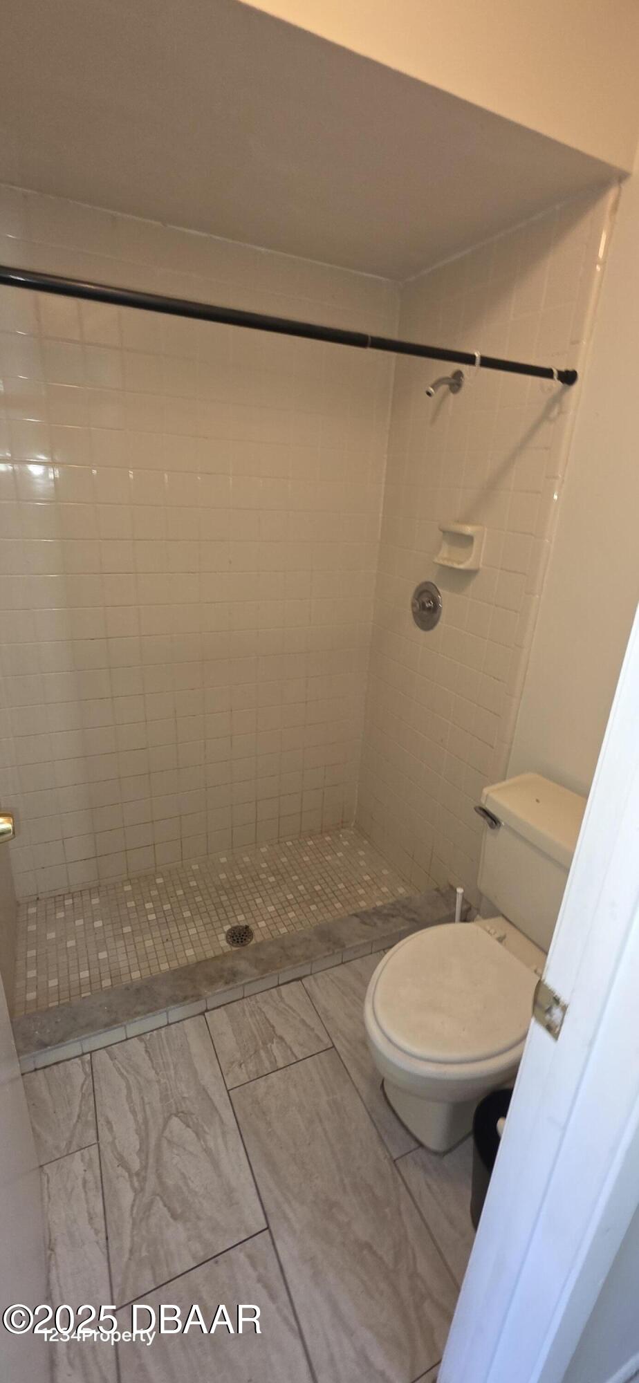 12136 Sand Pebble Way Orlando, FL 32824 - Photo 10 of 14 a bathroom with a toilet and a shower