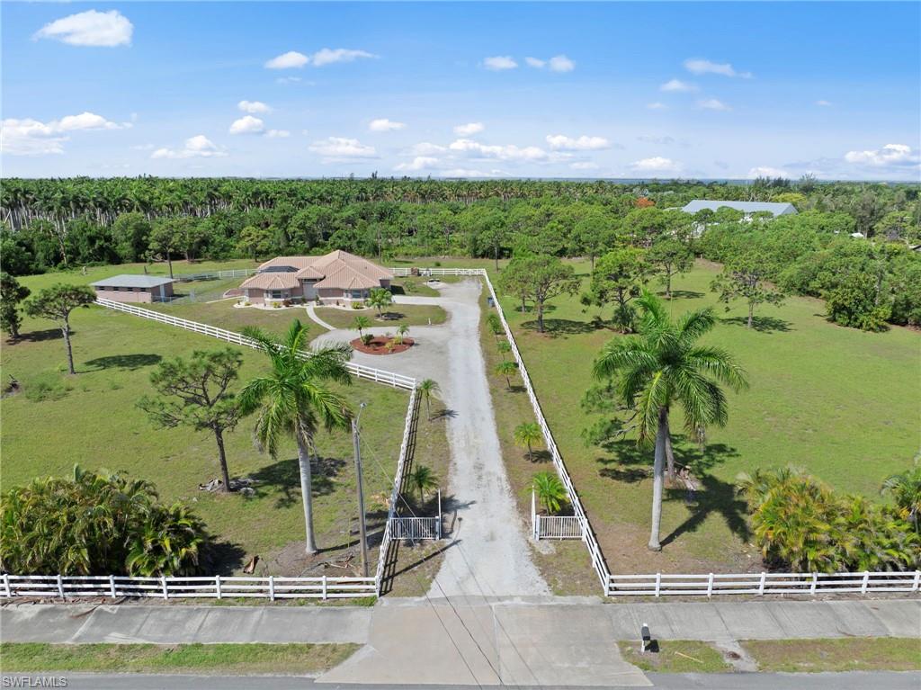 13541 Stringfellow Road Bokeelia, FL 33922 - Photo 38 of 49 a view of a swimming pool with an outdoor seating and a floor to ceiling window