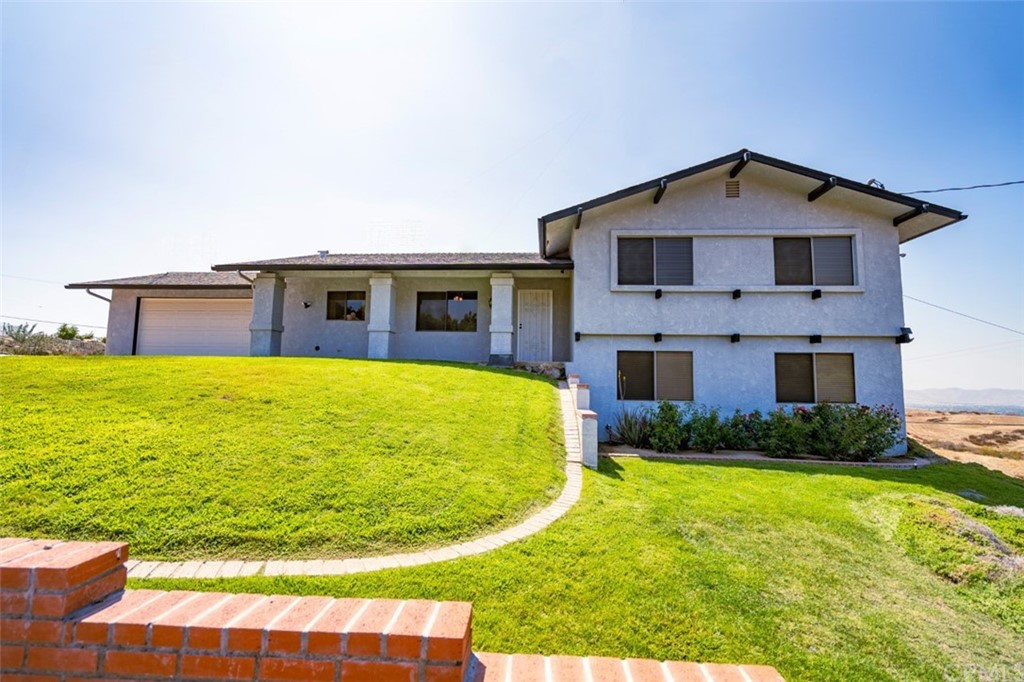 28255 Rawlings Road Hemet, CA 92544 - Photo 1 of 1 a front view of a house with a yard and garage