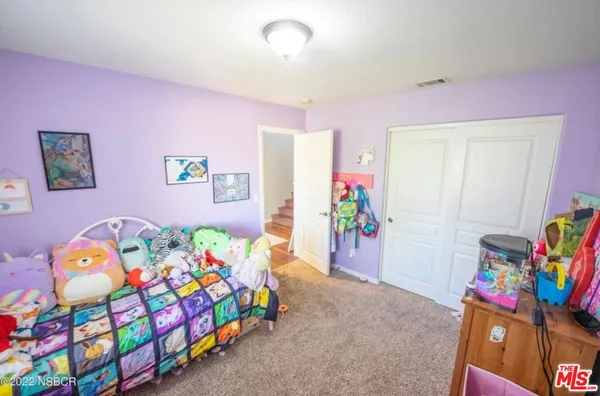 a bedroom with a bed window and toys