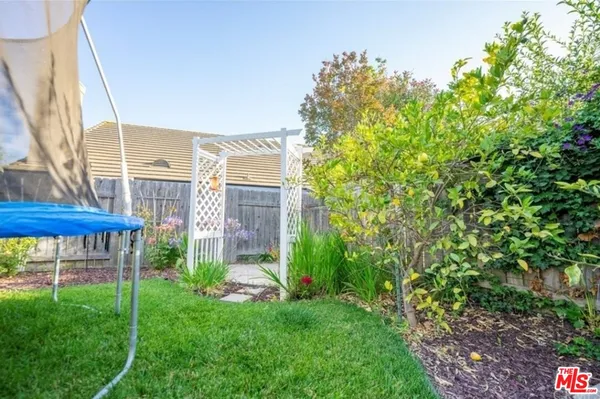 a view of a house with backyard porch and sitting area