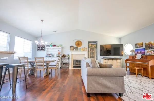 a living room with furniture a fireplace and a flat screen tv