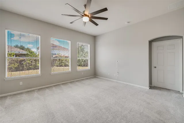 a view of a livingroom with a window and a ceiling fan