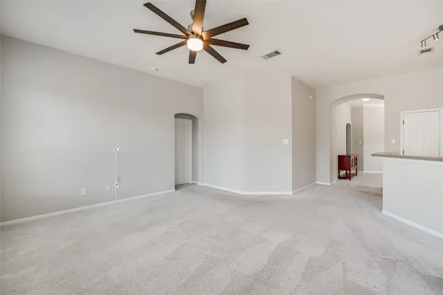 an empty room with fan and a ceiling fan
