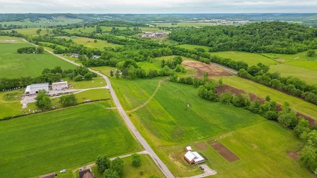 a view of a field with grass and a houses