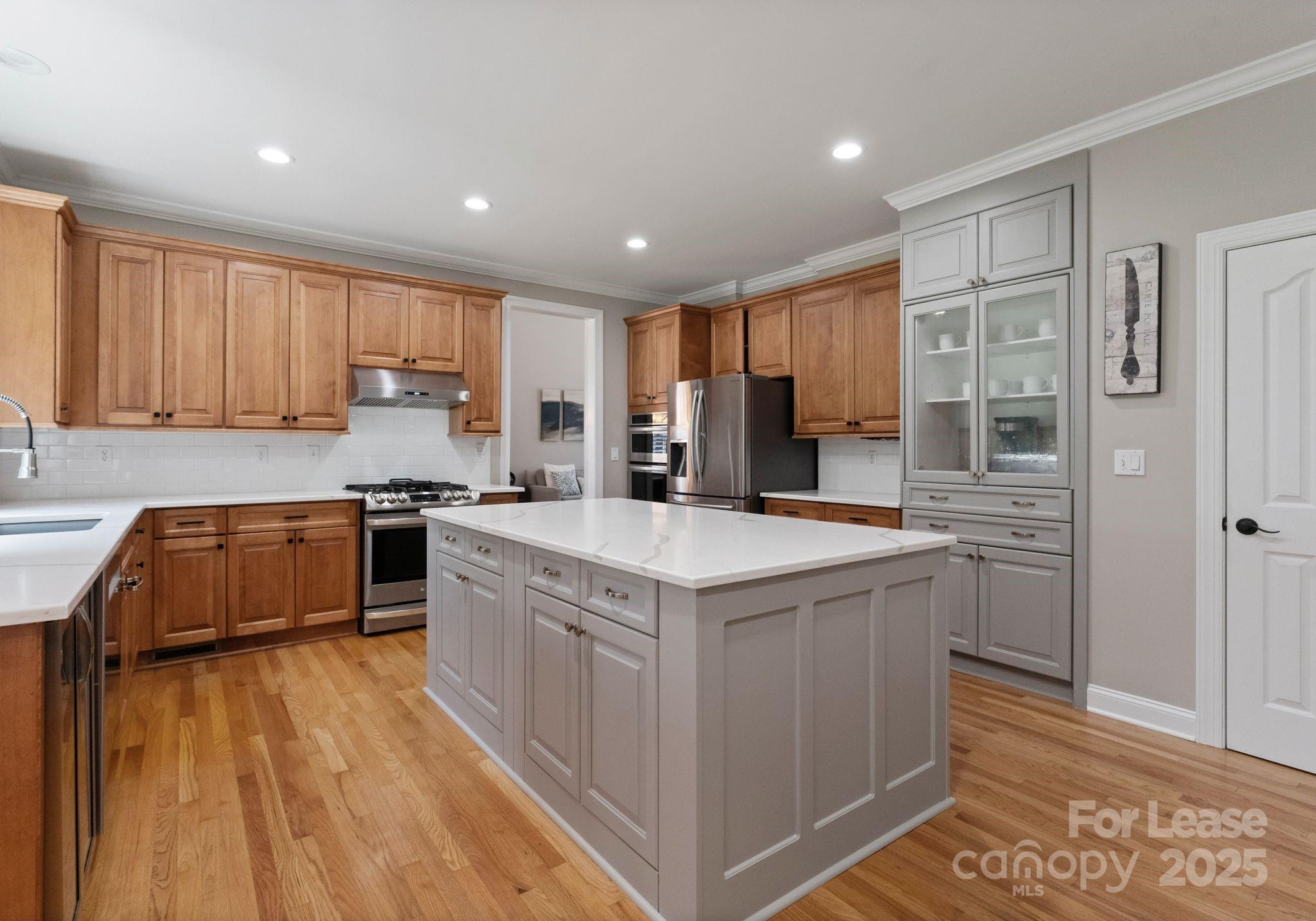 18807 Dembridge Drive Davidson, NC 28036 - Photo 12 of 35 a kitchen with stainless steel appliances granite countertop a stove and a refrigerator