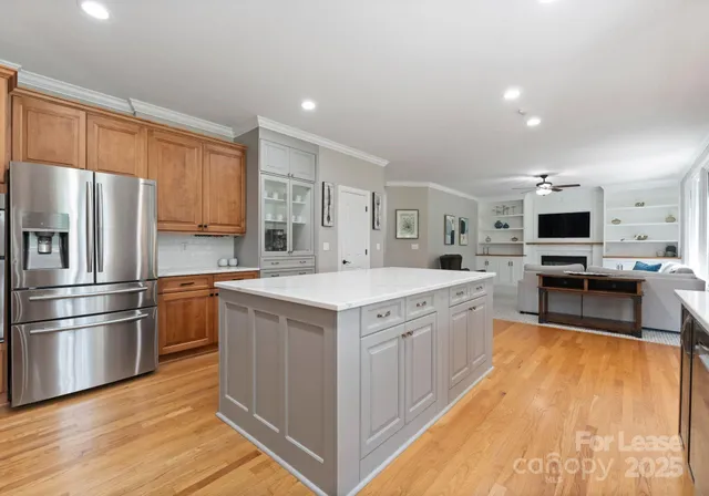 a kitchen with stainless steel appliances granite countertop a stove oven and a refrigerator