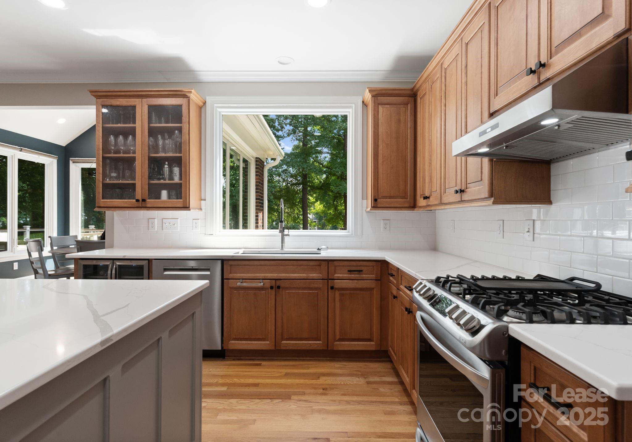 18807 Dembridge Drive Davidson, NC 28036 - Photo 14 of 35 a kitchen with stainless steel appliances granite countertop a stove and a sink