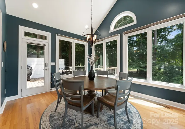 a dining room with furniture a chandelier and a rug