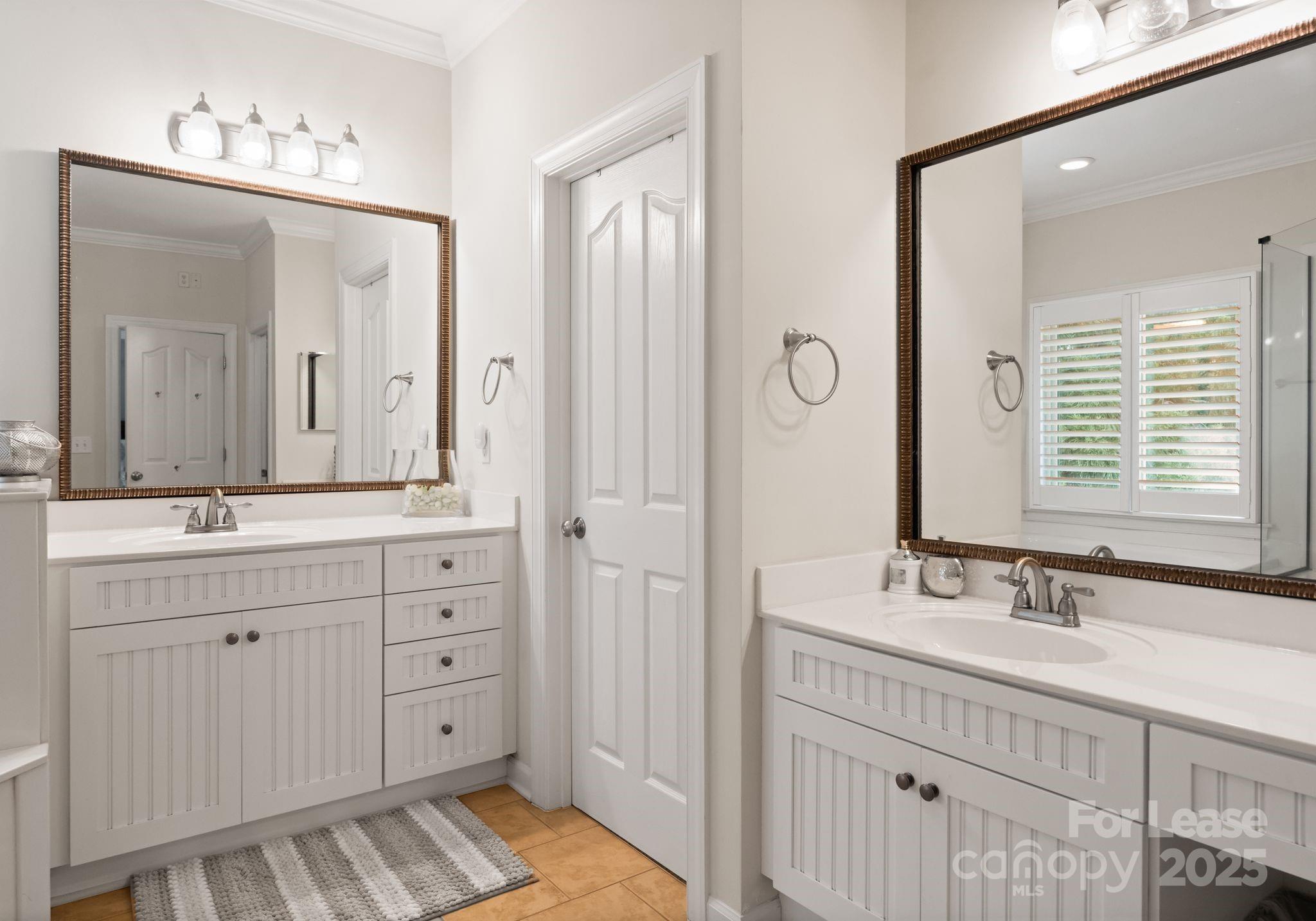 18807 Dembridge Drive Davidson, NC 28036 - Photo 24 of 35 a bathroom with double vanity sinks and a mirror
