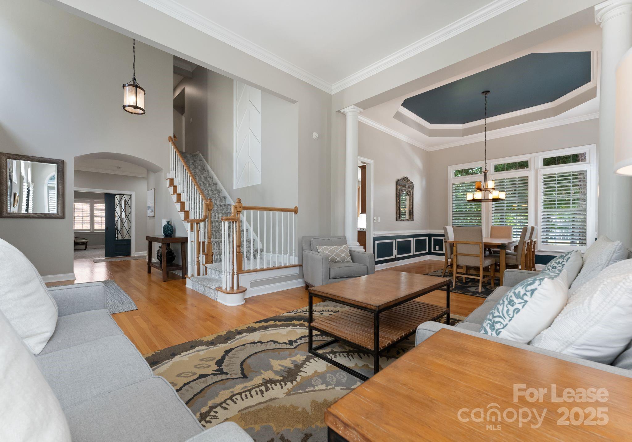 18807 Dembridge Drive Davidson, NC 28036 - Photo 3 of 35 a living room with furniture wooden floor and a large window