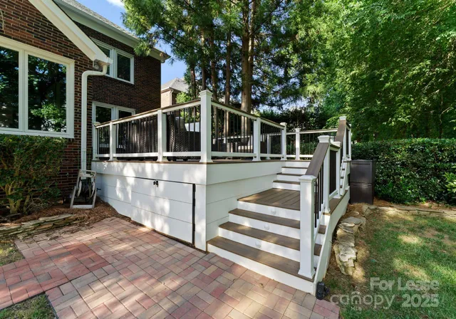 a view of a house with backyard and deck