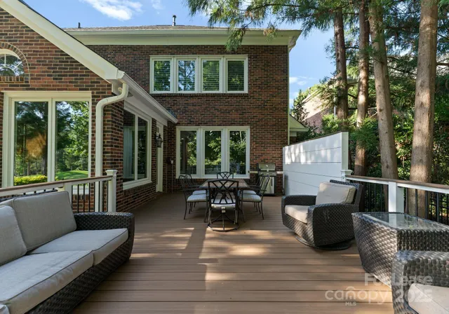 a view of a patio with couches table and chairs and potted plants