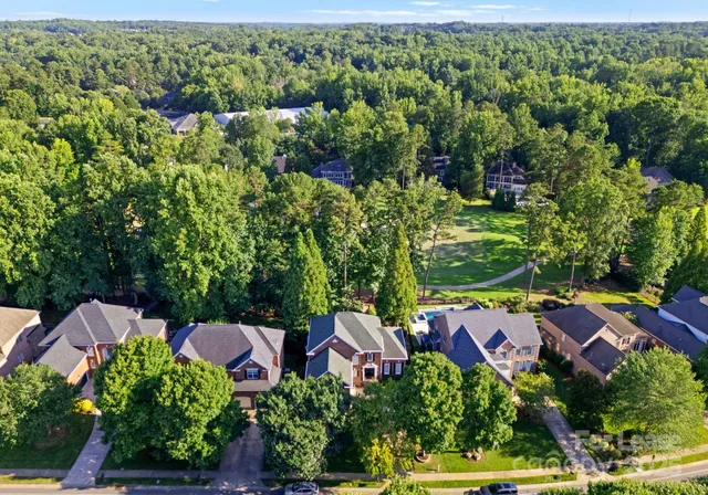 an aerial view of a house with yard swimming pool and outdoor seating