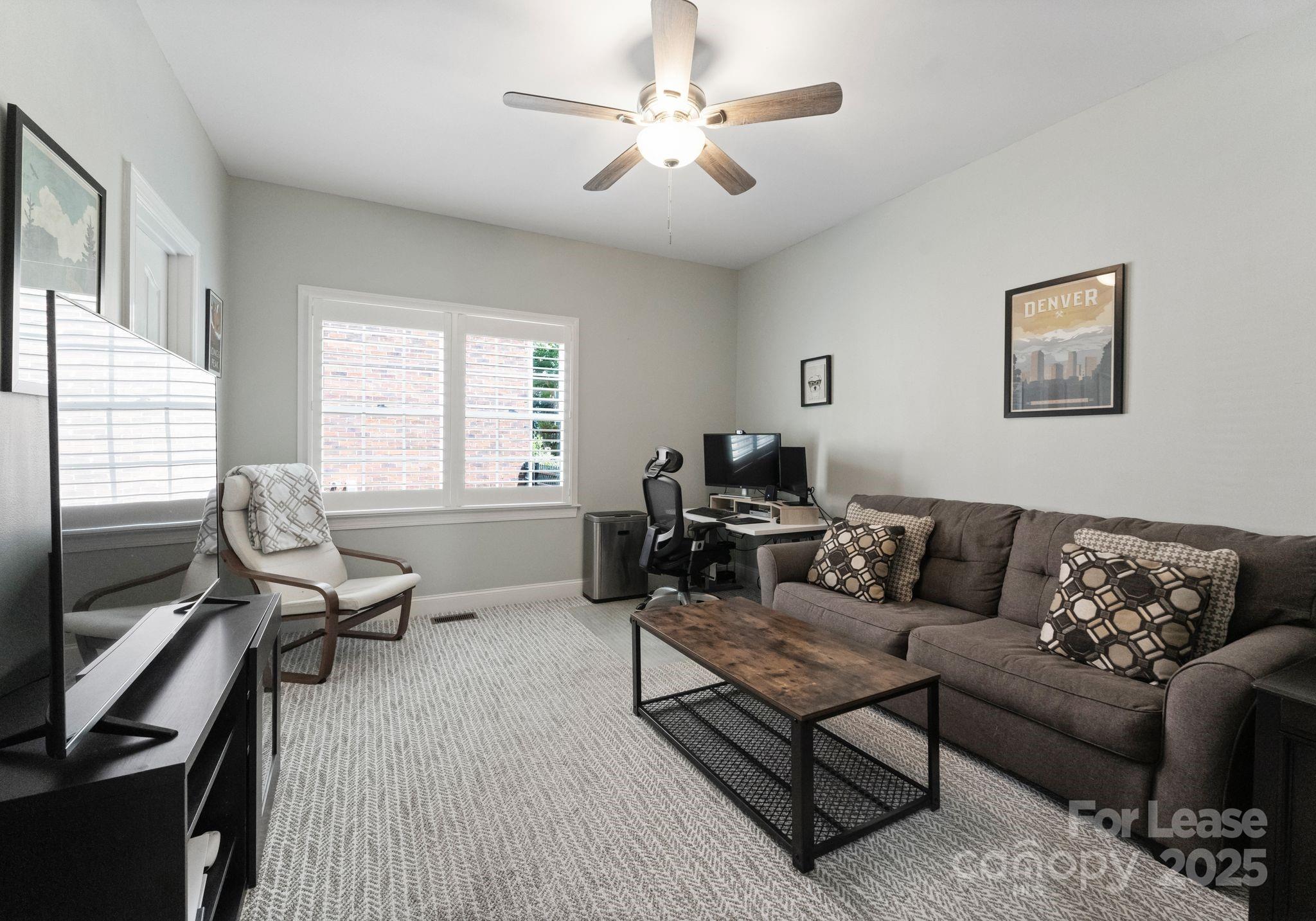 18807 Dembridge Drive Davidson, NC 28036 - Photo 5 of 35 a living room with furniture two window and a ceiling fan