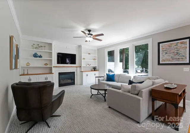 a living room with furniture a fireplace and a flat screen tv
