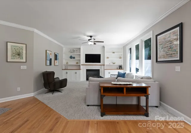 a living room with furniture a fireplace and a flat screen tv