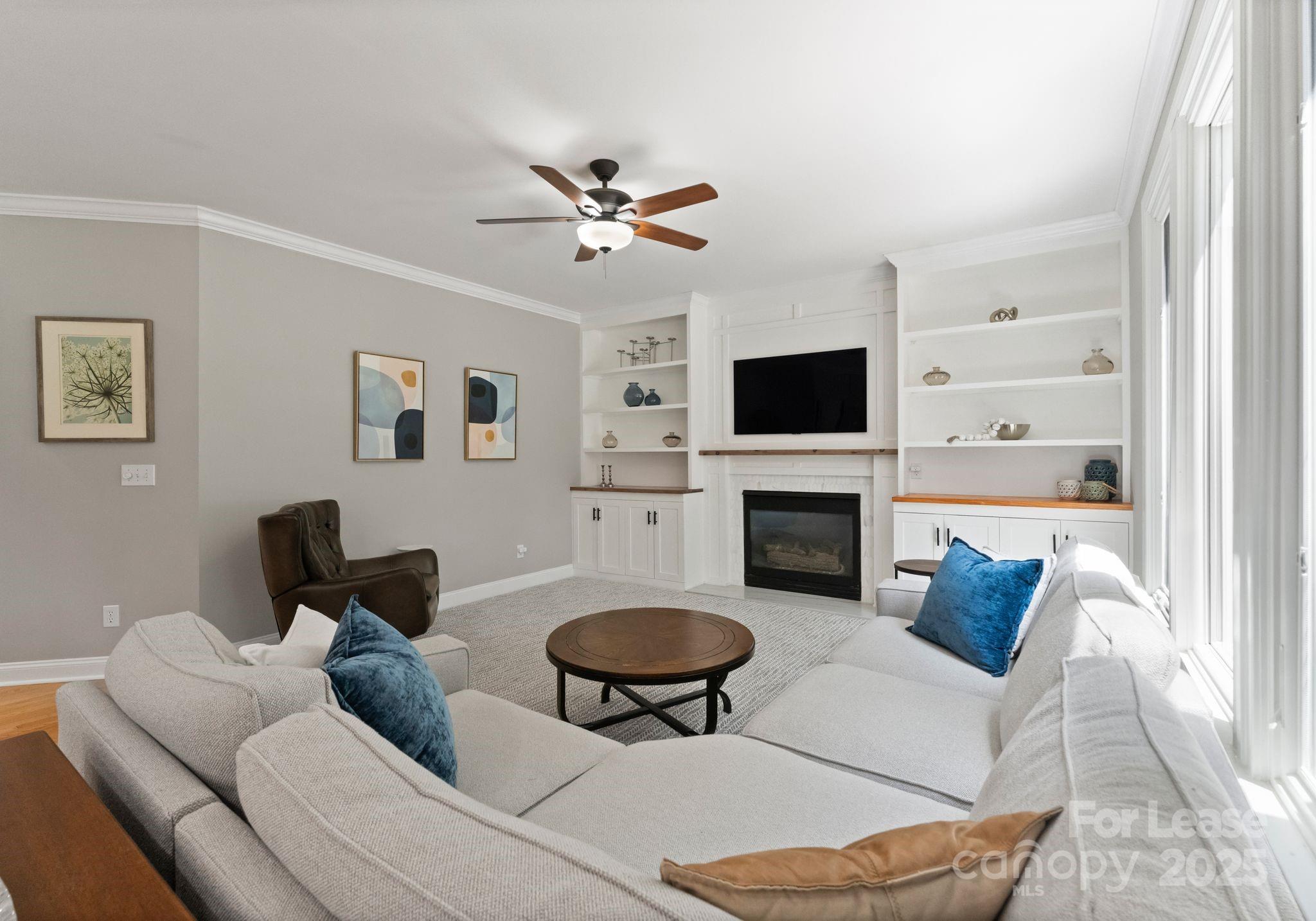 18807 Dembridge Drive Davidson, NC 28036 - Photo 9 of 35 a living room with furniture a fireplace and a flat screen tv