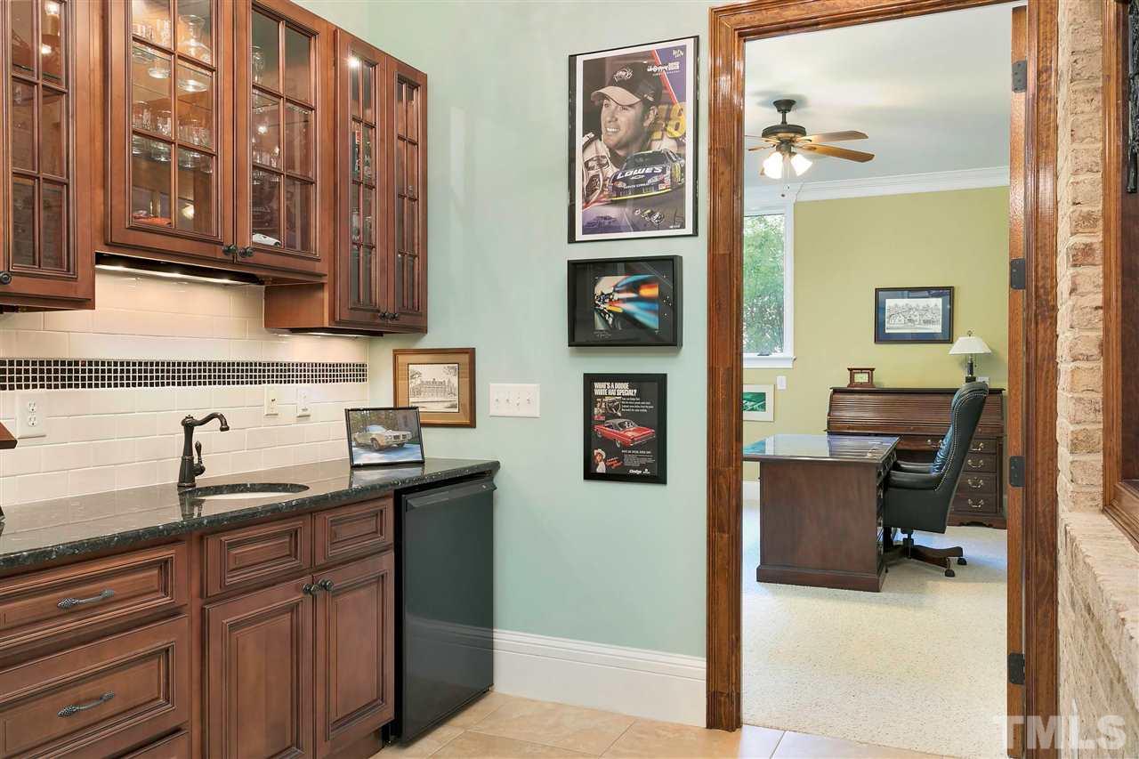 302 Annandale Drive Cary, NC 27511 - Photo 26 of 30 a kitchen with stainless steel appliances granite countertop a sink stove and cabinets