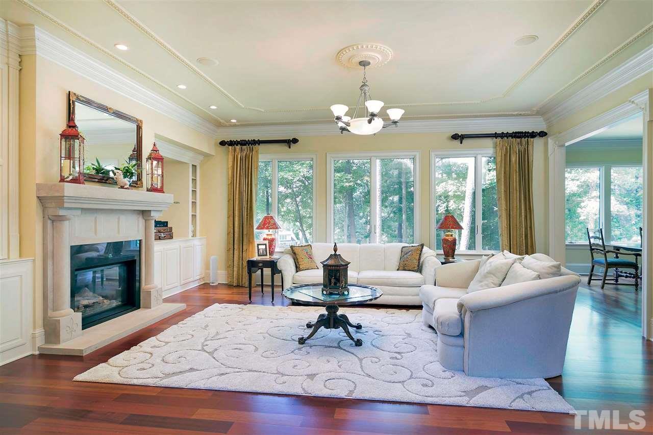 302 Annandale Drive Cary, NC 27511 - Photo 6 of 30 a living room with furniture fireplace and large windows
