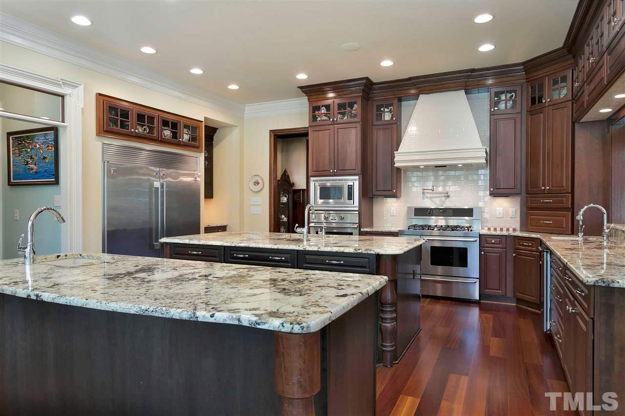 302 Annandale Drive Cary, NC 27511 - Photo 7 of 30 a kitchen with stainless steel appliances granite countertop a sink stove and refrigerator