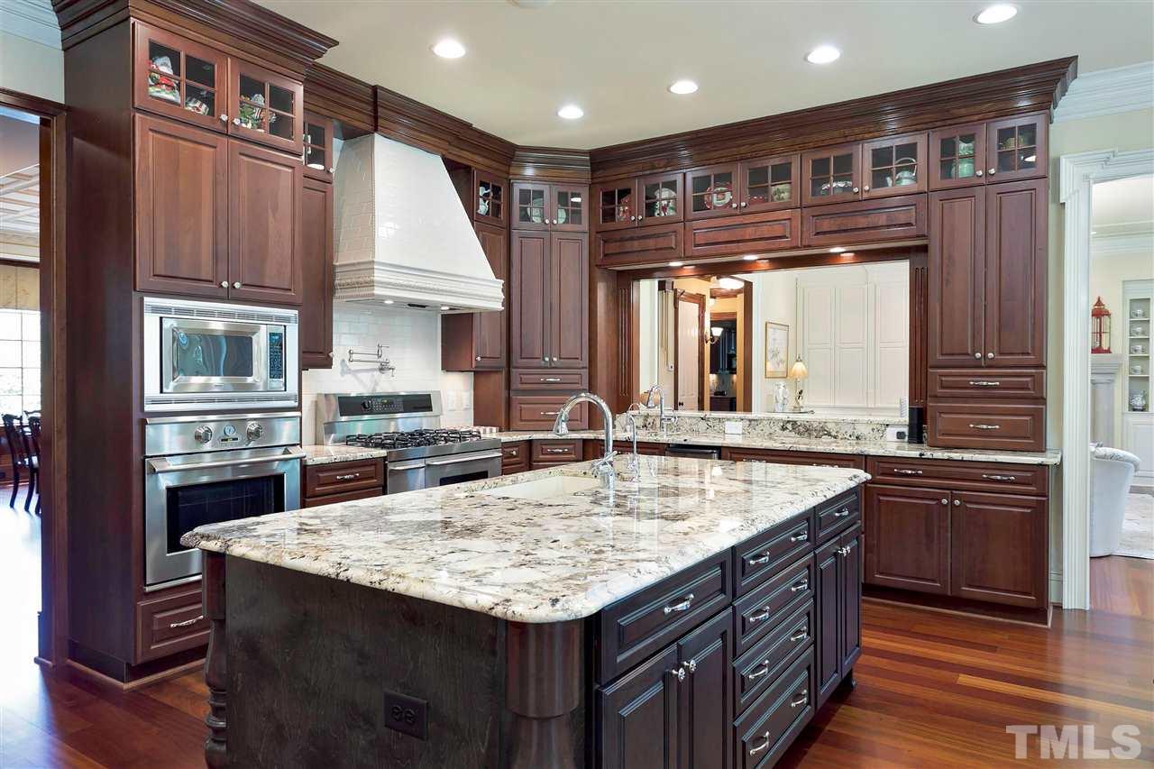 302 Annandale Drive Cary, NC 27511 - Photo 8 of 30 a kitchen with kitchen island granite countertop a large stove a sink and dishwasher