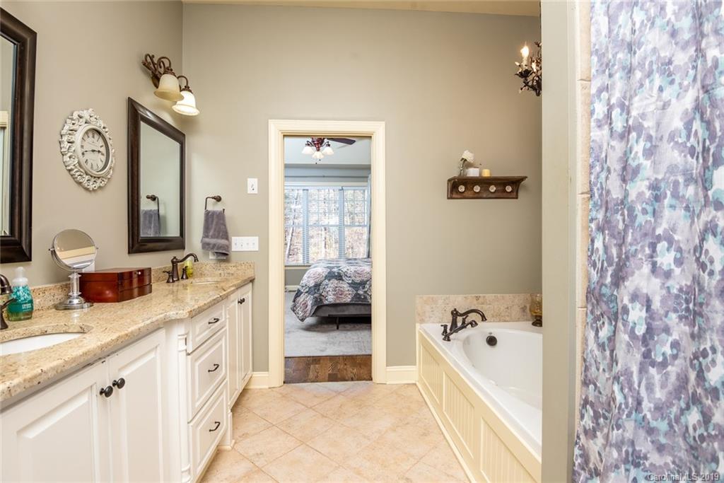 2056 Roadrunner Road Clover, SC 29710 - Photo 12 of 25 a large bathroom with a tub sink and mirror