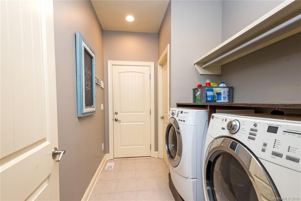2056 Roadrunner Road Clover, SC 29710 - Photo 17 of 25 a view of washer and dryer with kitchen in the background