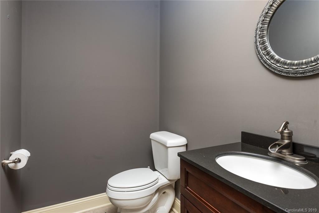 2056 Roadrunner Road Clover, SC 29710 - Photo 19 of 25 a bathroom with a granite countertop toilet and a sink