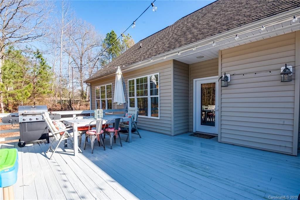 2056 Roadrunner Road Clover, SC 29710 - Photo 20 of 25 a view of a patio with table and chairs potted plants and wooden fence