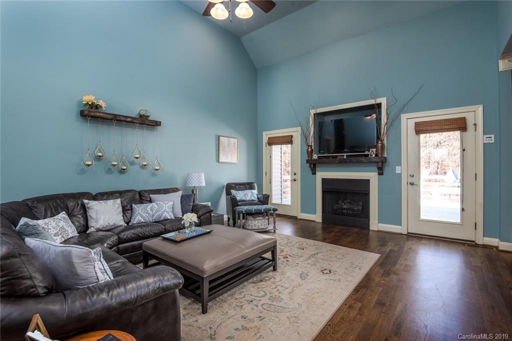 2056 Roadrunner Road Clover, SC 29710 - Photo 5 of 25 a living room with furniture a flat screen tv and a fireplace